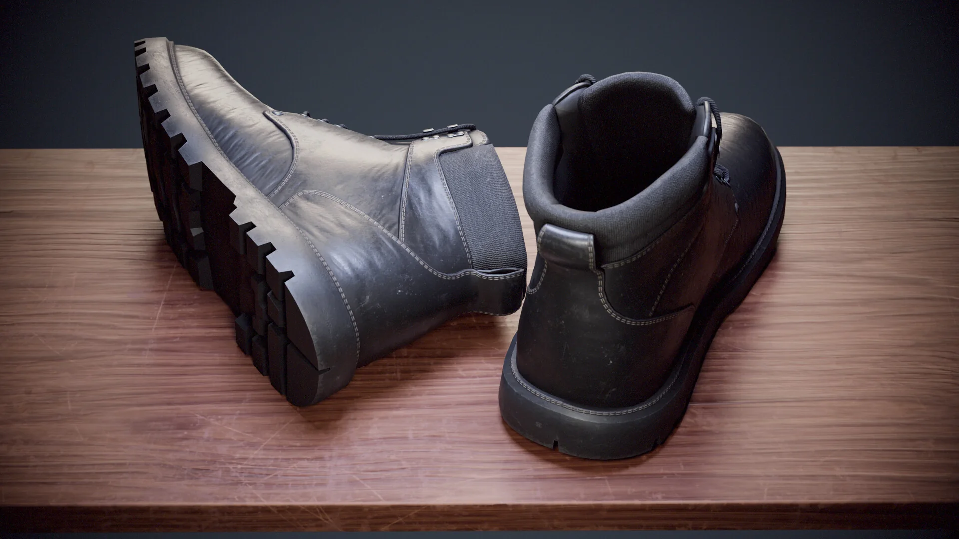 Close view from behind, one boot tipped to show the treaded sole.