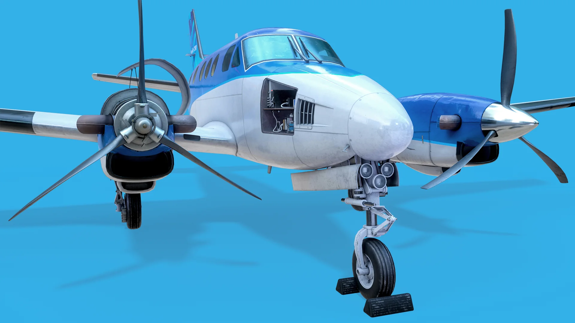 Three-quarter front view of the King Air C90 with the nose avionics bay open, nose gear extended and both PT6 propellers visible.