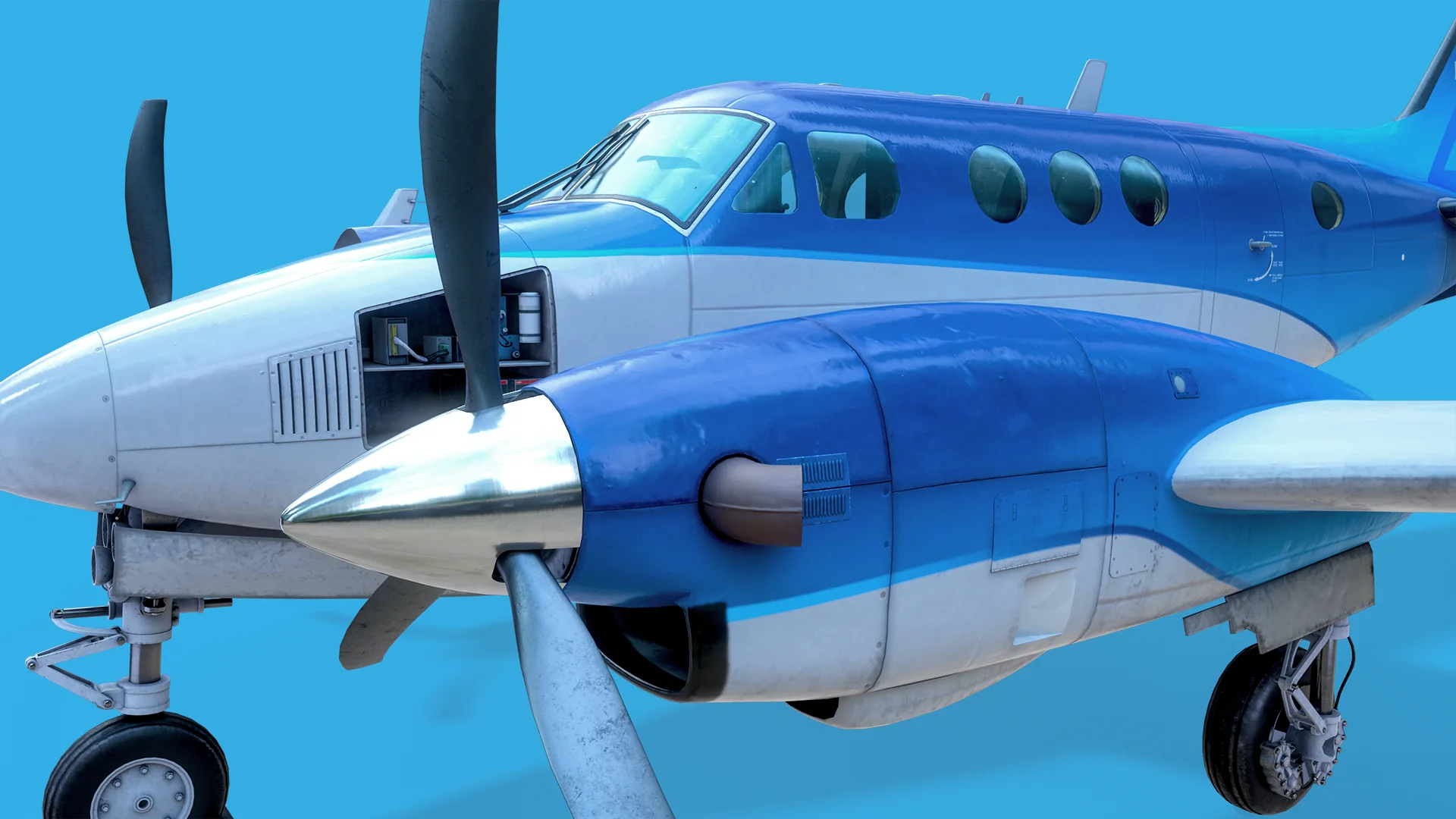 Close-up of the right engine nacelle, spinner and propeller, with the cockpit windows and cabin behind.