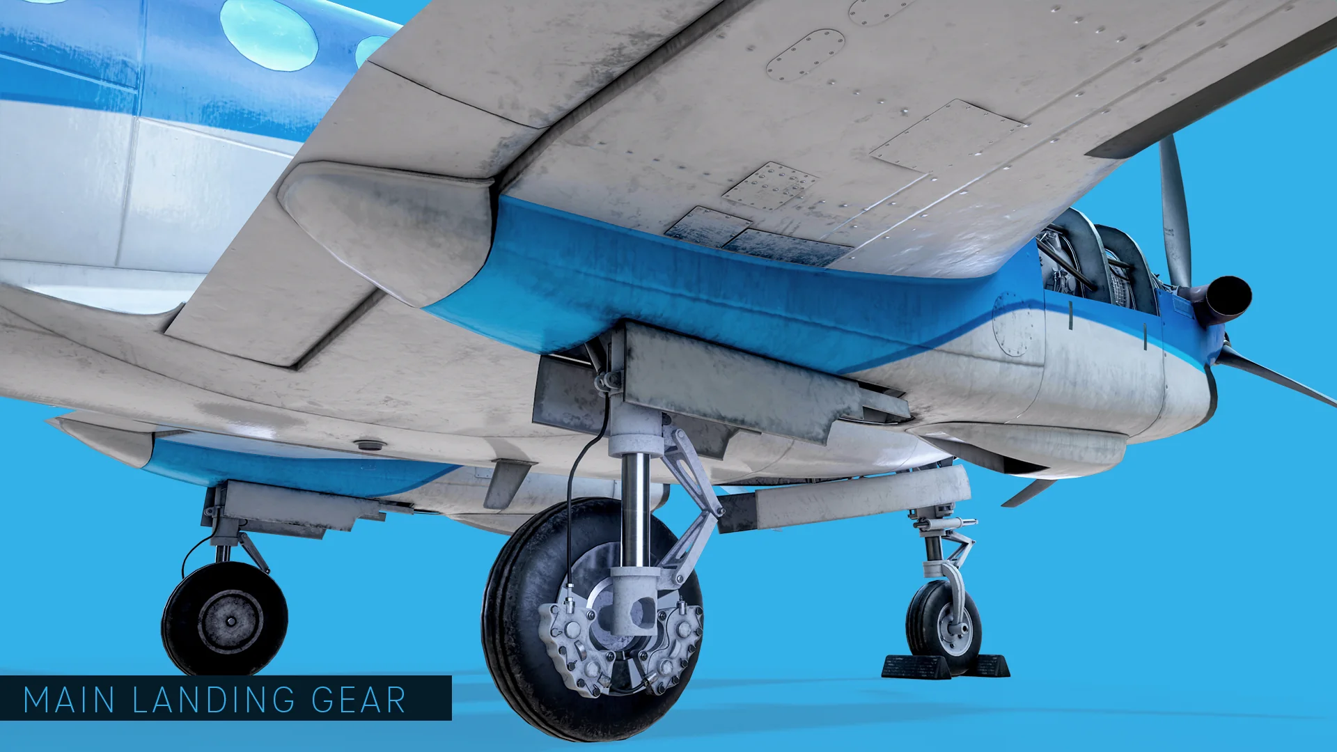 Main landing gear seen from below the wing, showing the brake assembly, torque arms and open gear bay.
