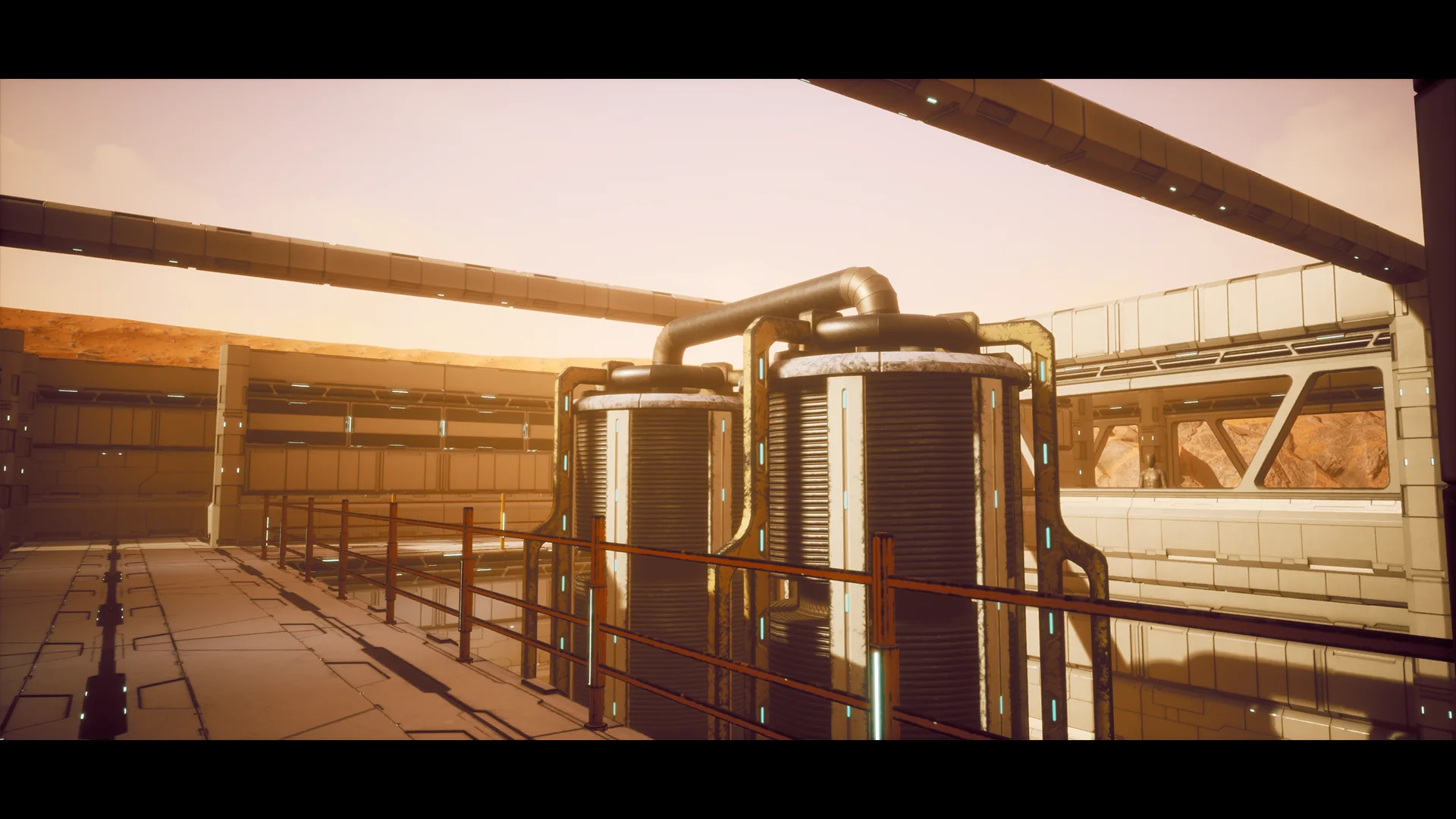 Exterior walkway with railings running past two cylindrical tanks and their pipework, canyon visible beyond.