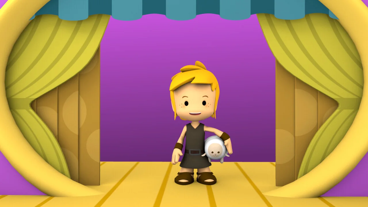 David standing on a theatre stage framed by yellow curtains.