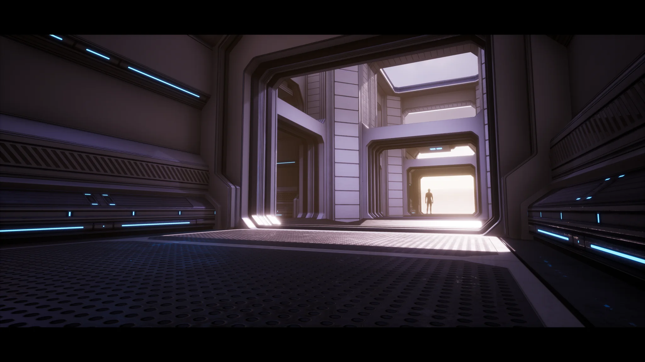 Wide interior bay with a figure silhouetted against the daylight in the far doorway.